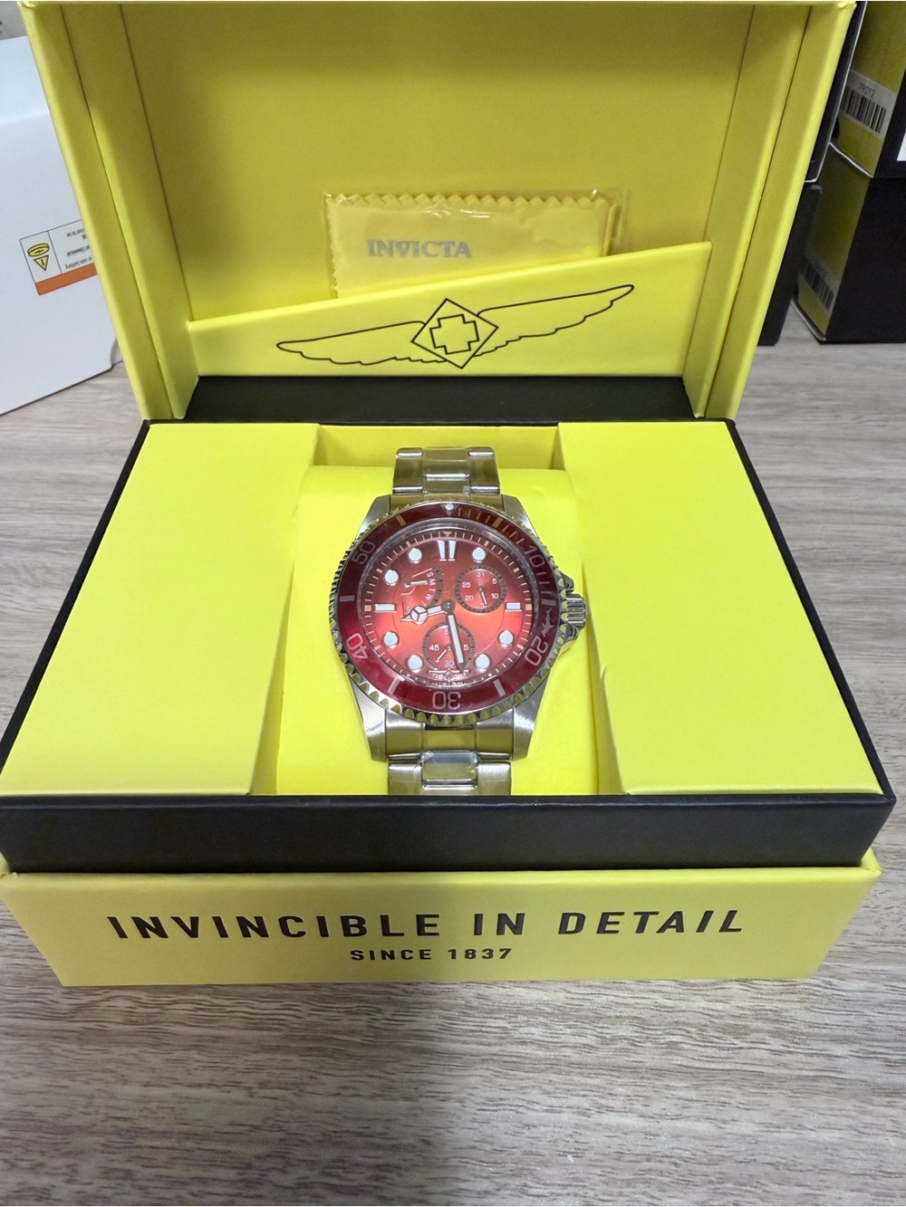Invicta Pro Diver series stainless steel watch featuring a striking red dial